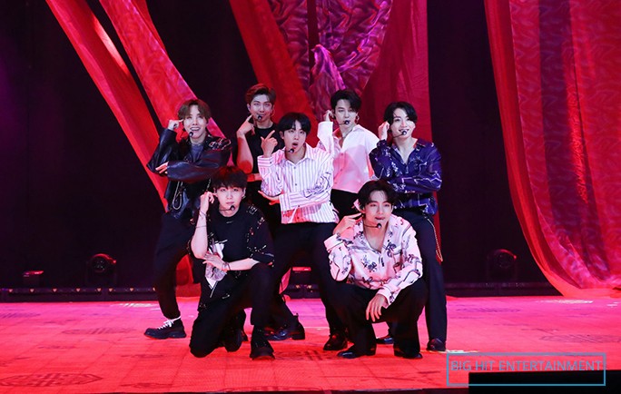 bts performing in red background