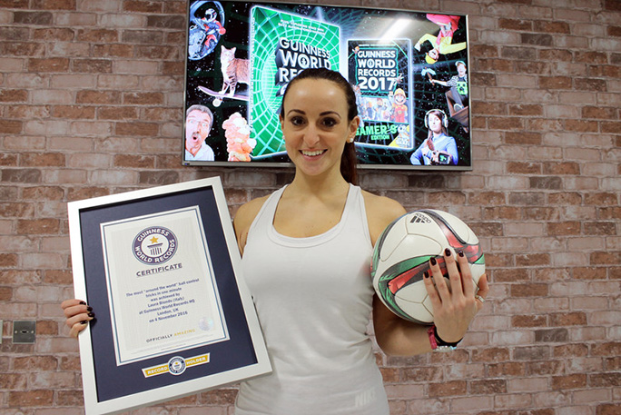 Laura posed with certificate holding soccer ball