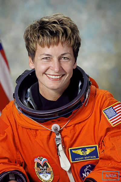 peggy whitson in an orange flight suit