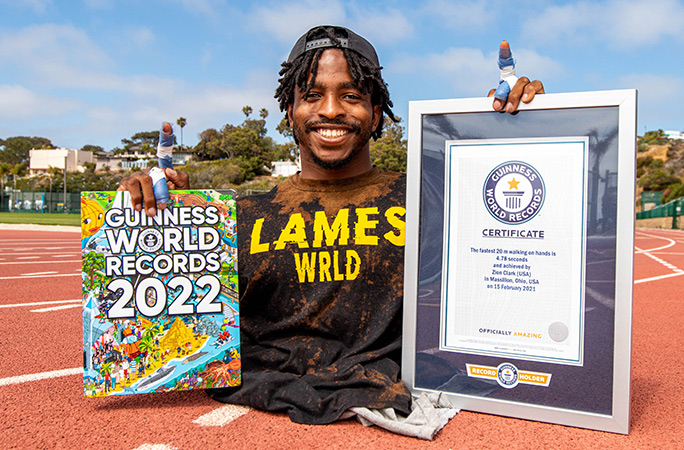 Zion Clark holding Guinness World Recirds book and certificate