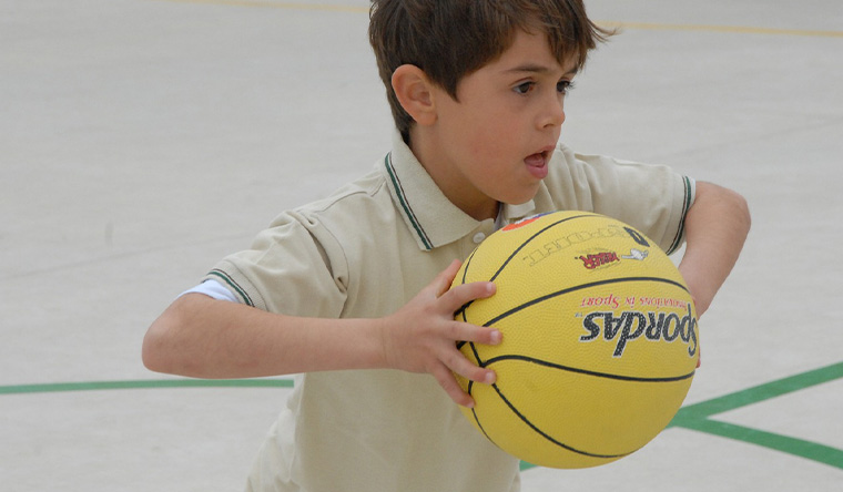 Boy with ball on chest