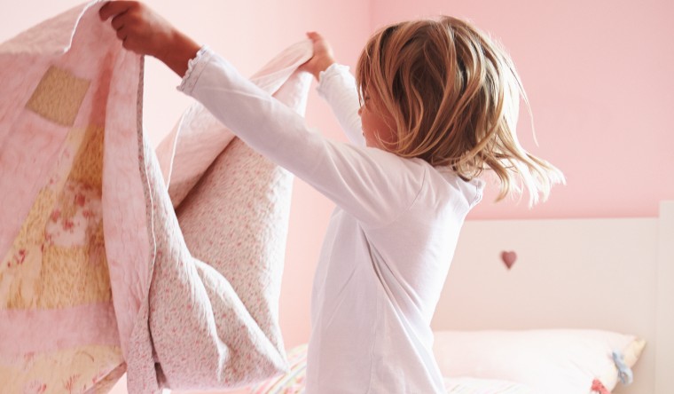girl making her pink bed
