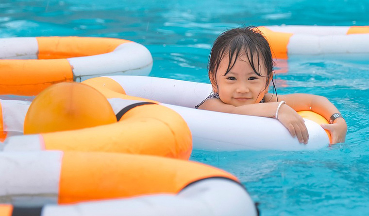 Kid in the pool with rubber rings