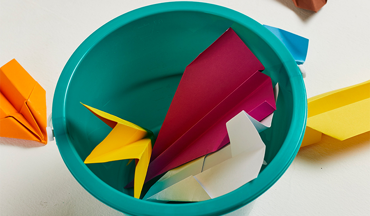paper planes in a green bucket
