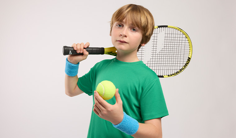Boy with racket and tennis ball