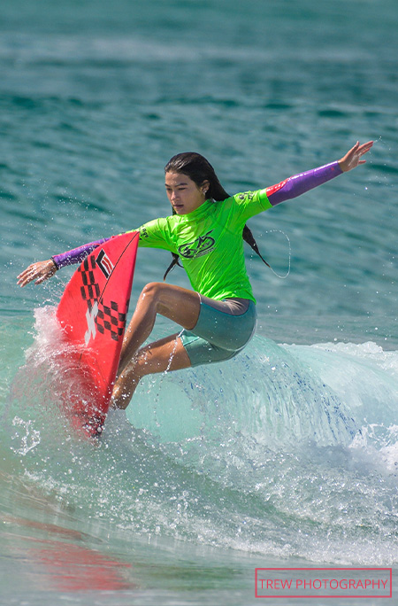 Arisa Trew surfing