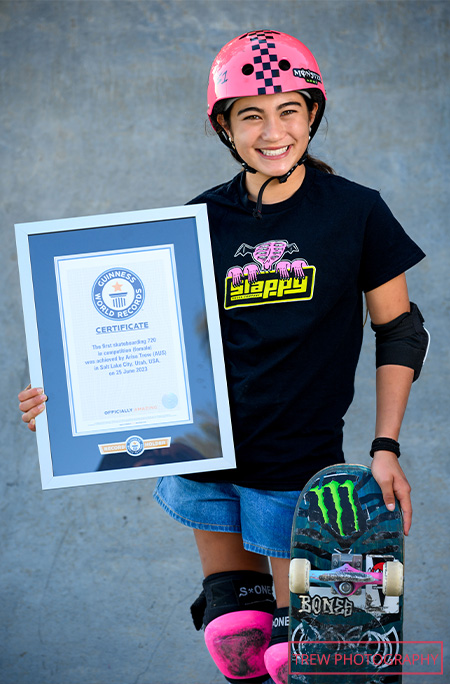 Arisa with skateboard and certificate