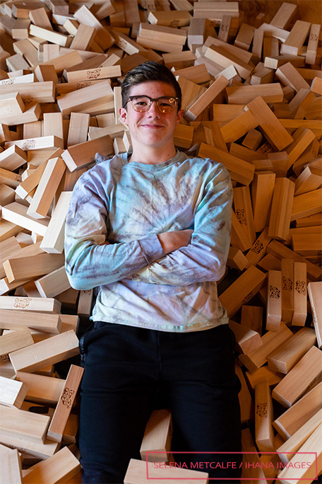 Auldin laying in a pile of Jenga blocks