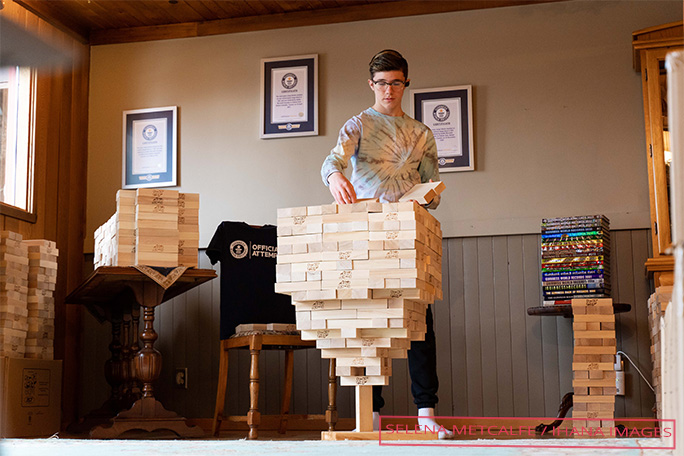 Auldin midway through stacking jenga blocks