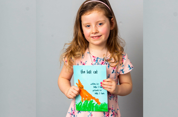 Bella holding a book