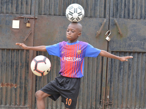 Chinonso balancing ball on head while doing kick ups