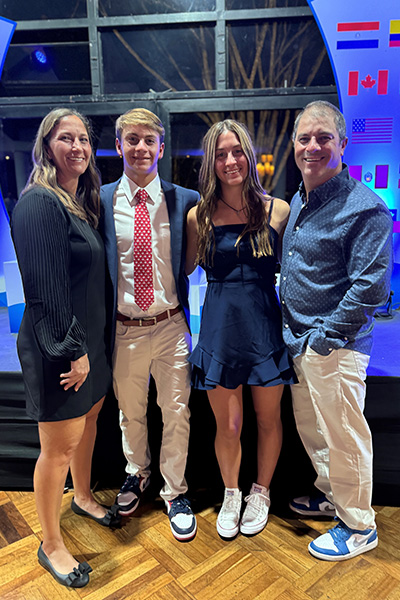 Jake Abelson stood with his mum sister and dad at a formal event