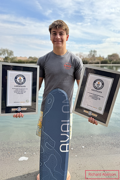 Jake Abelson holding his two framed GWR certificates