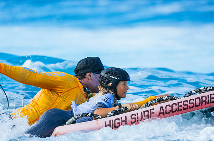 Kelia surfing with dad