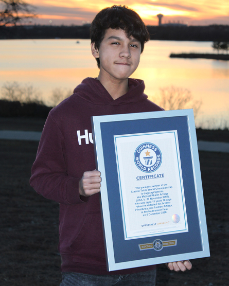 michael wearing burgundy holding gwr certificate