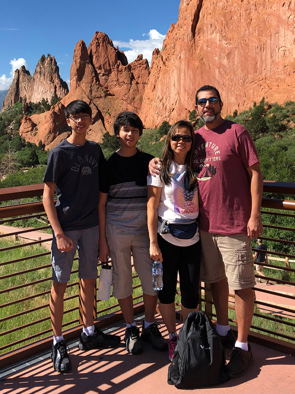 michael and his family in front of a mountainous landscape