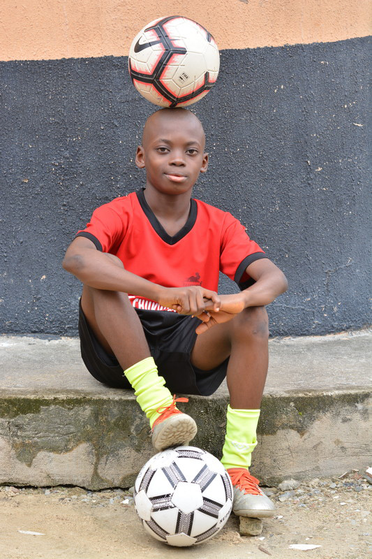 Chinonso balancing football on head and posing for picture