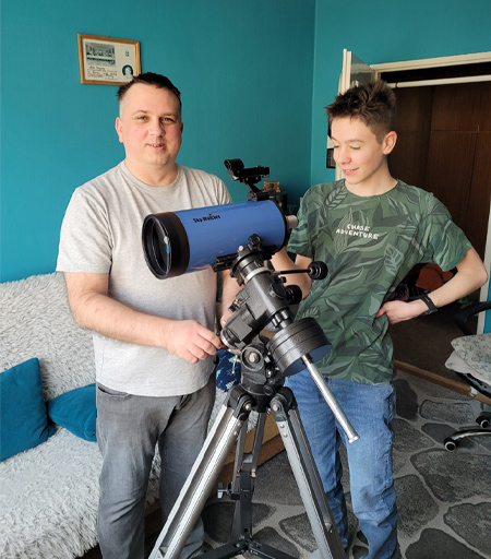 Rafal with a telescope next to man