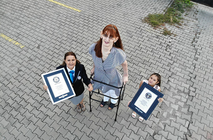 Rumeysa looking up with certificates