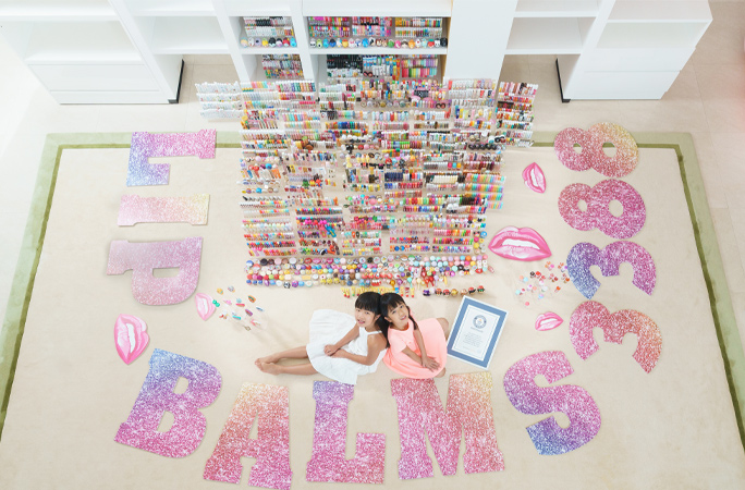 scarlett and her sister with their collection of lip balms