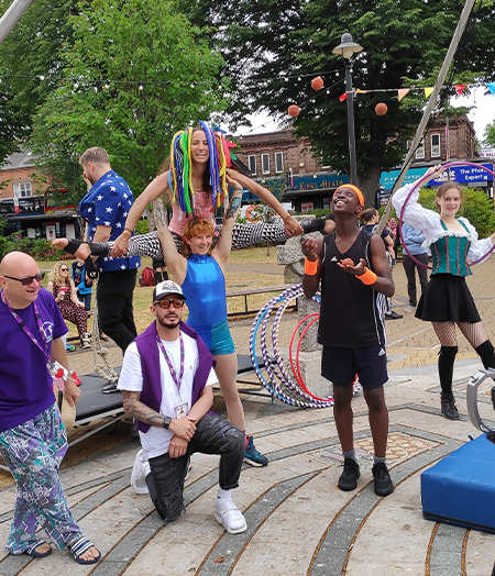 Simeon Graham juggling in a group with other performers