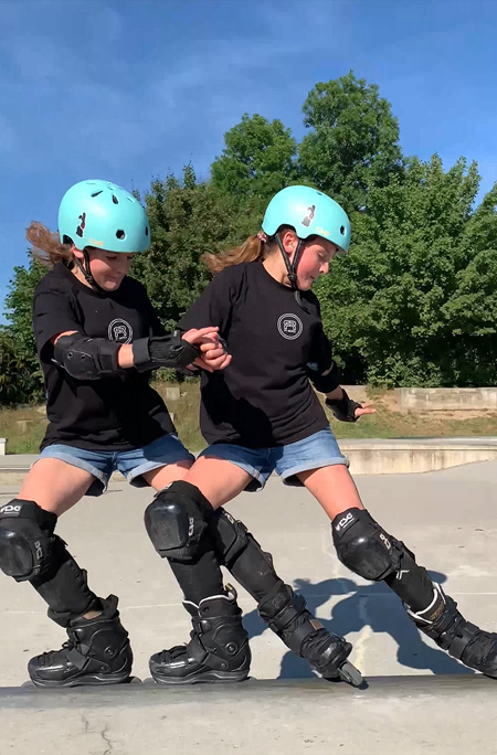Twins skating side by side