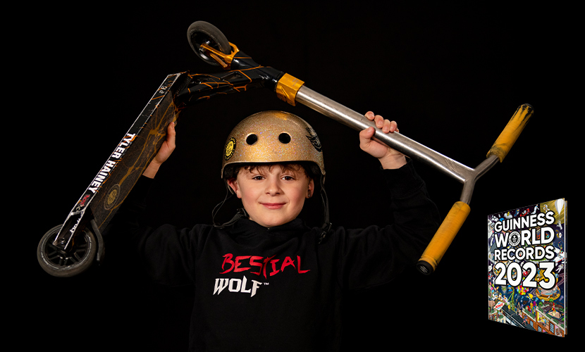 tyler holding scooter over head