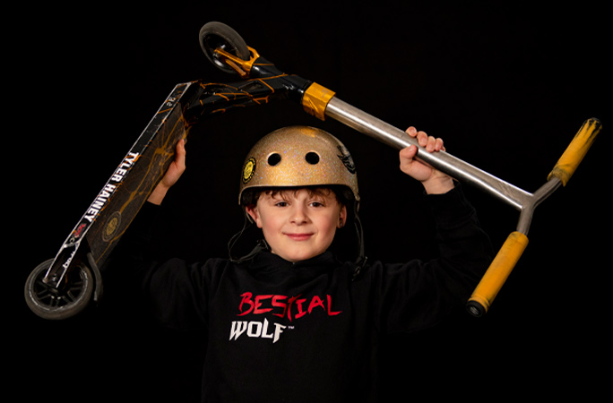 tyler holding scooter above head