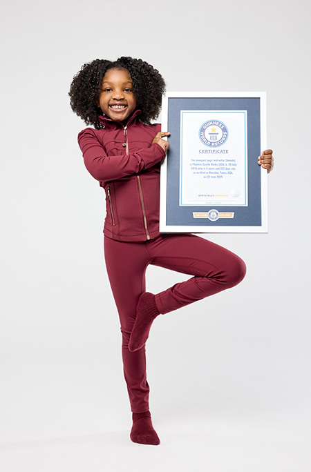 Phoenix doing tree pose with certificate