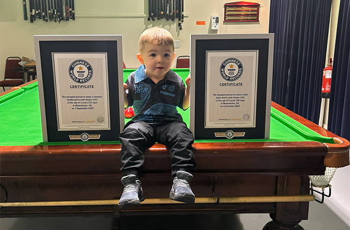 Jude holding two record certificates