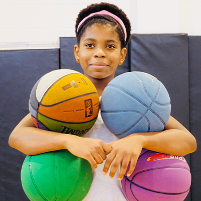 Zaila Avant-garde holding multiple basketballs