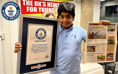 Aneeshwar holding certificate and newspaper