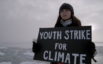mya rose holding a sign for climate change