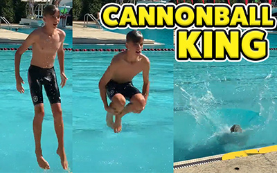 boy doing cannonball by pool 