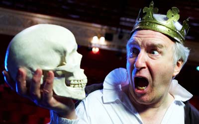 man holding fake skull 