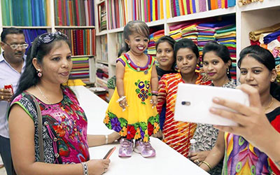 jyoti standing on table while taking picture with other women