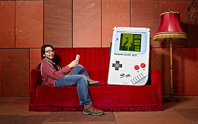 man next to the largest game boy