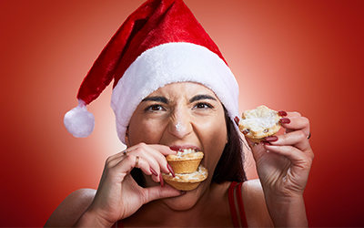 Leah Shutkever wearing christmas hat and eating christmas treats
