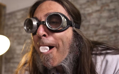man wearing goggles with marshmallow in mouth