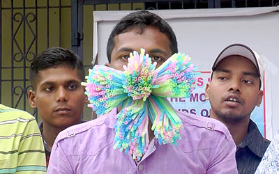 man with hundreds of straws in his mouth
