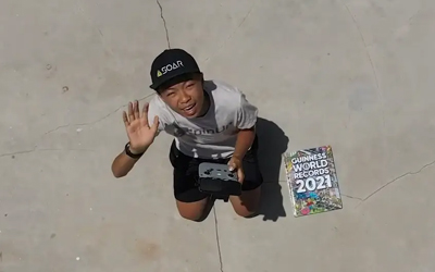 youngest drone cartographer waving at drone camera